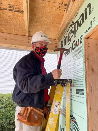 Photo of Lyle Hanna volunteering at a Habitat for Humanity home building project