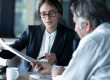 Photo of an HR consultant reviewing paperwork with a client