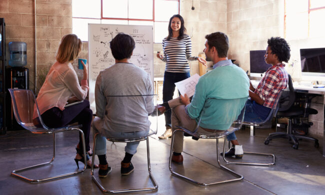 Photo of a team conducting an organizational development exercise at a whiteboard