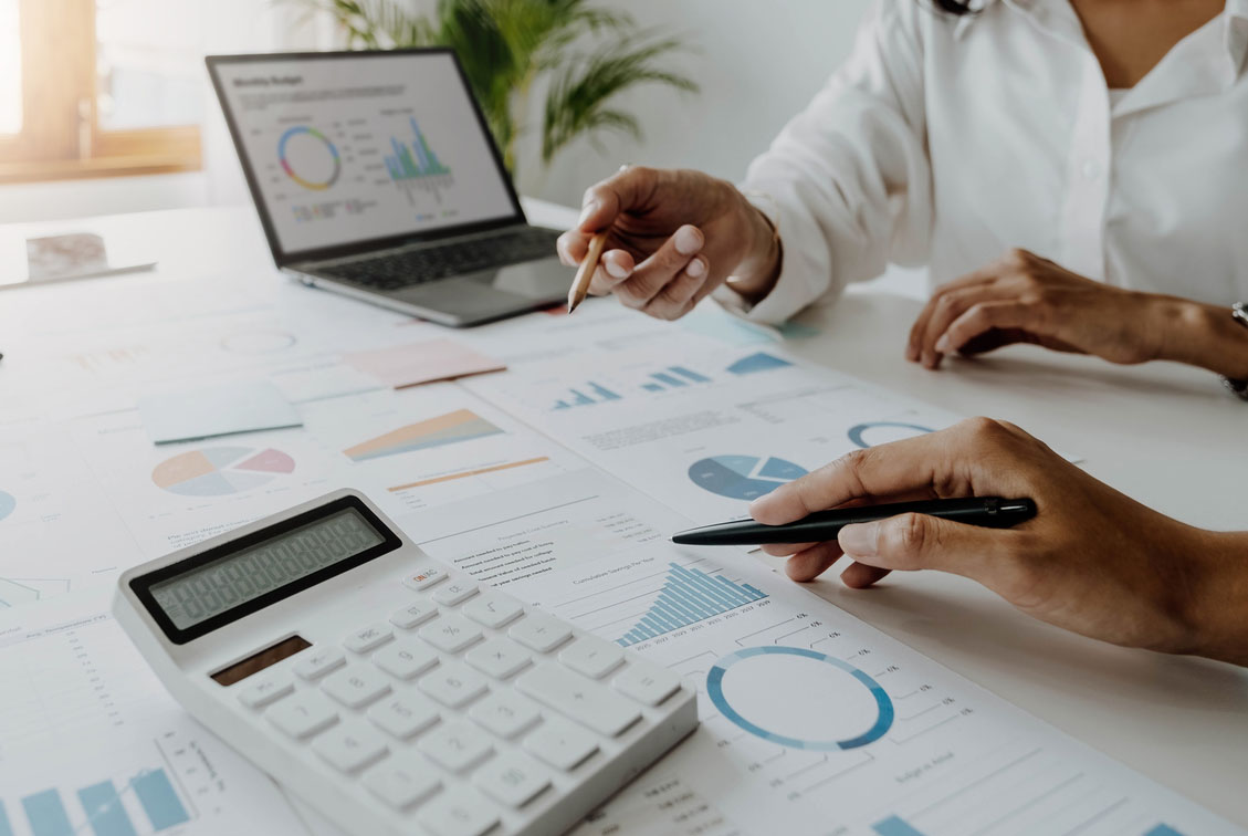 Two-Professionals-Discussing-HR-Metrics-HRG Photo of two HR professionals reviewing paperwork with metrics