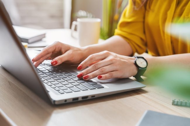 Photo of an HR professional typing a job description